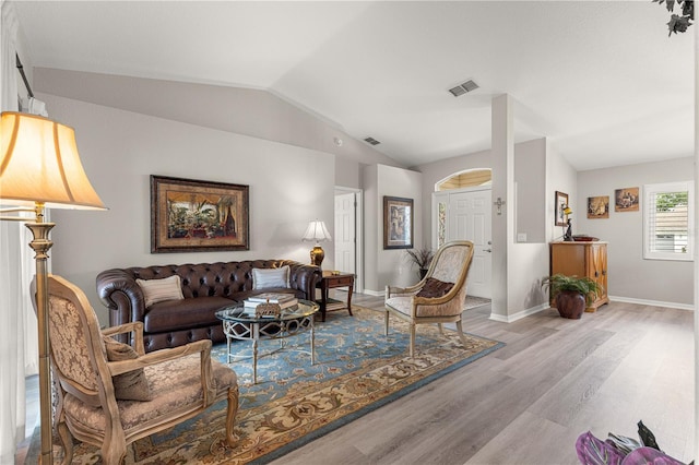 13715 SE 88th Ct, Summerfield, FL 34491 - living area featuring wood finished floors, vaulted ceiling, and baseboards