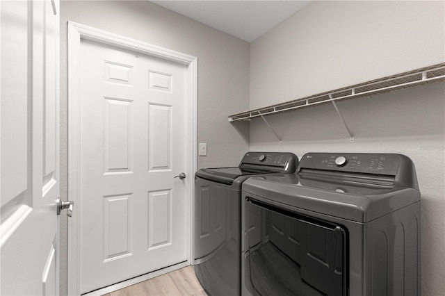 13715 SE 88th Ct, Summerfield, FL 34491 - washroom with independent washer and dryer and light wood-style floors
