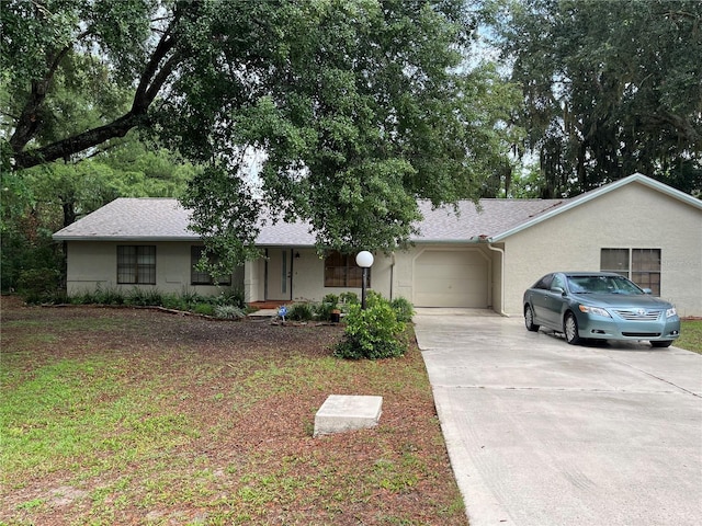 519 Spring Lake Rd, Ocala, FL 34472 - ranch-style house with driveway, a garage, stucco siding, and roof with shingles