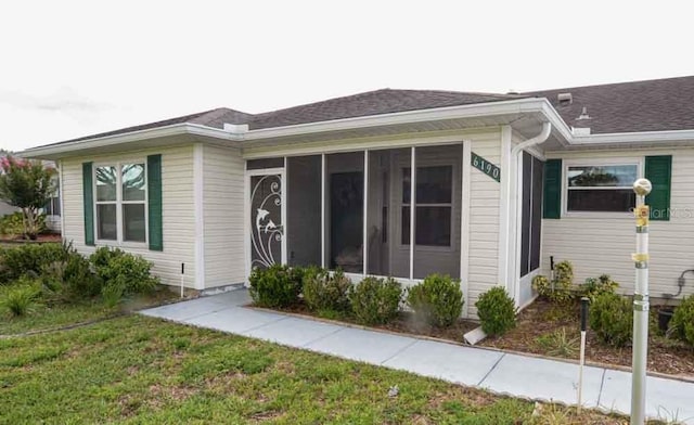 6190 SW 84th Pl, Ocala, FL 34476 - view of front of home featuring a sunroom and roof with shingles