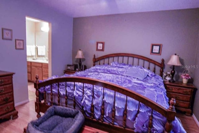 6190 SW 84th Pl, Ocala, FL 34476 - bedroom with connected bathroom and baseboards