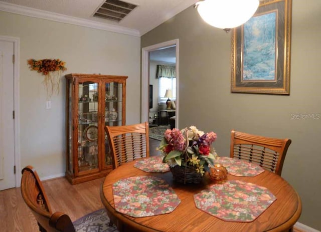 6190 SW 84th Pl, Ocala, FL 34476 - dining space featuring wood finished floors, ornamental molding, and baseboards
