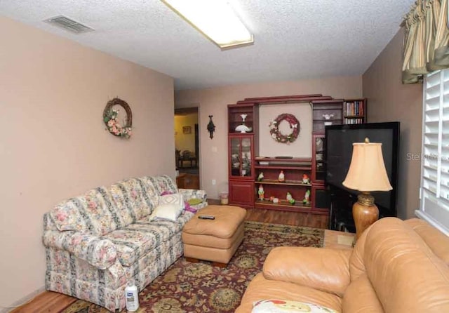 6190 SW 84th Pl, Ocala, FL 34476 - living area featuring a textured ceiling and wood finished floors