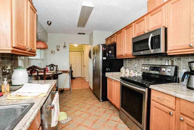 6190 SW 84th Pl, Ocala, FL 34476 - kitchen with appliances with stainless steel finishes, light flooring, tasteful backsplash, a sink, and light stone countertops