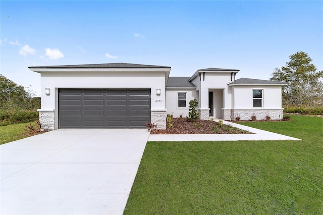16195 SW 48th Cir, Ocala, FL 34473 - prairie-style home with stone siding, an attached garage, concrete driveway, and stucco siding