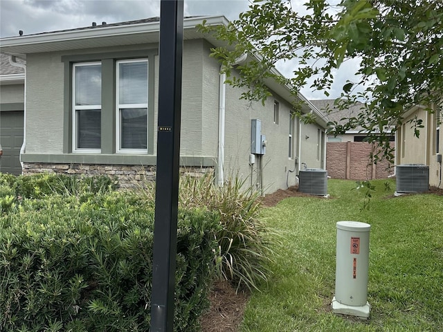 5255 NW 33rd Pl, Ocala, FL 34482 - view of side of home with central AC and stucco siding