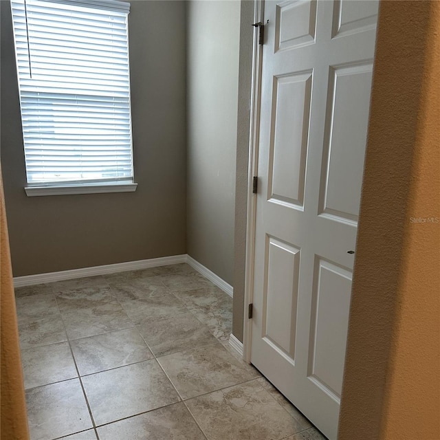 5255 NW 33rd Pl, Ocala, FL 34482 - spare room with baseboards and light tile patterned flooring