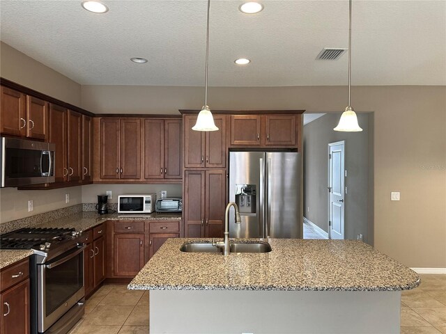 5255 NW 33rd Pl, Ocala, FL 34482 - kitchen with stainless steel appliances, a sink, light tile patterned flooring, light stone countertops, and recessed lighting