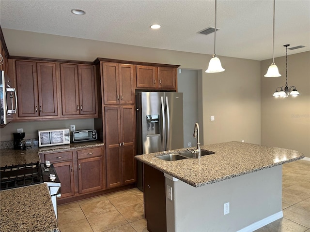 5255 NW 33rd Pl, Ocala, FL 34482 - kitchen featuring a sink, appliances with stainless steel finishes, light tile patterned floors, decorative light fixtures, and light stone countertops