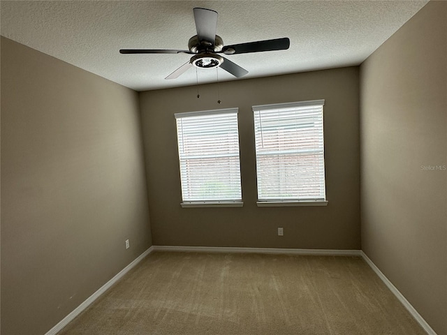 5255 NW 33rd Pl, Ocala, FL 34482 - empty room with a ceiling fan, a textured ceiling, light colored carpet, and baseboards