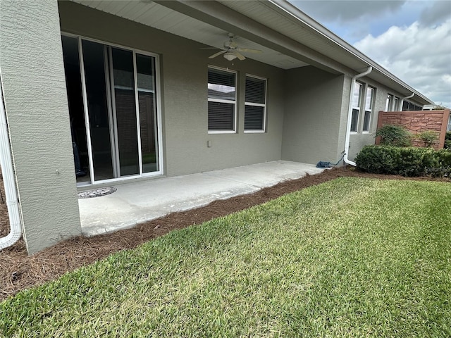 5255 NW 33rd Pl, Ocala, FL 34482 - back of house featuring a yard, a ceiling fan, and stucco siding