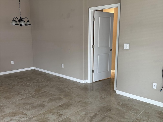 5255 NW 33rd Pl, Ocala, FL 34482 - unfurnished room with a chandelier, baseboards, and tile patterned floors
