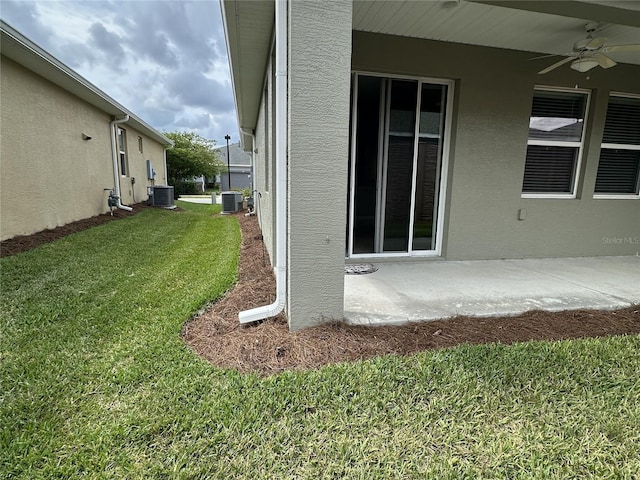 5255 NW 33rd Pl, Ocala, FL 34482 - view of green lawn with central air condition unit, a ceiling fan, and a patio area
