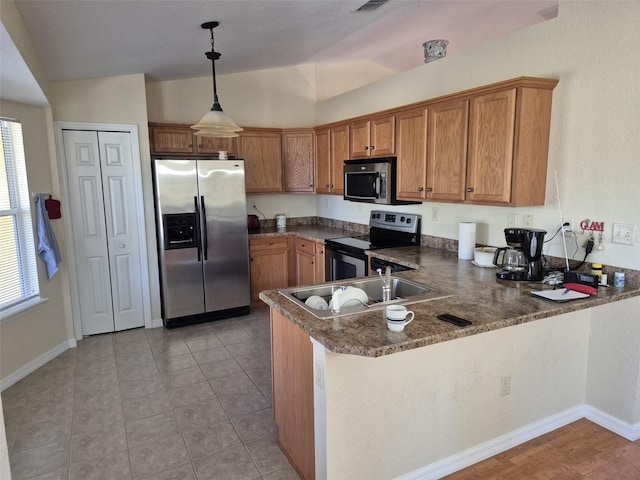 360 Marion Oaks Golf Way, Ocala, FL 34473 - kitchen with appliances with stainless steel finishes, brown cabinetry, a sink, a peninsula, and healthy amount of natural light