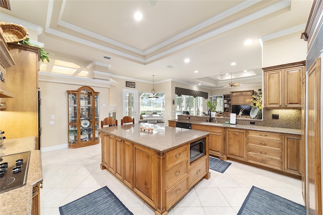7915 SE 12th Cir, Ocala, FL 34480 - kitchen featuring a tray ceiling, black appliances, light tile patterned floors, a sink, and crown molding