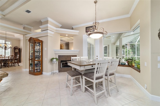 7915 SE 12th Cir, Ocala, FL 34480 - dining space with a chandelier, crown molding, a glass covered fireplace, and baseboards