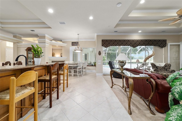 7915 SE 12th Cir, Ocala, FL 34480 - living area with ornamental molding, light tile patterned flooring, a tray ceiling, recessed lighting, and a ceiling fan