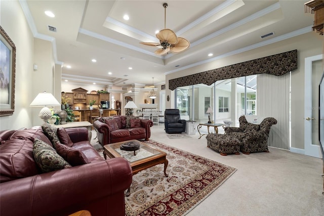 7915 SE 12th Cir, Ocala, FL 34480 - living room featuring light colored carpet, a raised ceiling, ceiling fan, crown molding, and recessed lighting