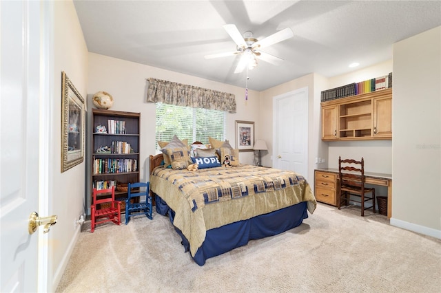 7915 SE 12th Cir, Ocala, FL 34480 - bedroom with light carpet, baseboards, and ceiling fan