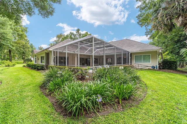 7915 SE 12th Cir, Ocala, FL 34480 - back of property with a yard, a lanai, a tile roof, and stucco siding