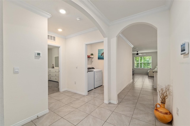 32 Hickory Course Loop, Ocala, FL 34472 - hallway featuring arched walkways, crown molding, light tile patterned flooring, washer and clothes dryer, and baseboards