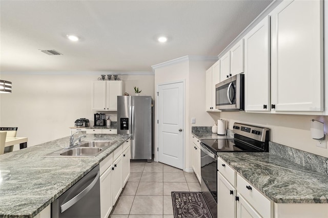 32 Hickory Course Loop, Ocala, FL 34472 - kitchen with stainless steel appliances, a sink, crown molding, white cabinetry, and light tile patterned flooring