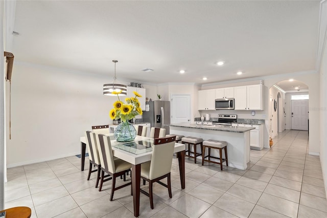 32 Hickory Course Loop, Ocala, FL 34472 - dining space with arched walkways, crown molding, light tile patterned flooring, recessed lighting, and baseboards