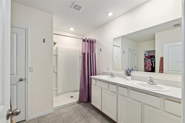 32 Hickory Course Loop, Ocala, FL 34472 - bathroom with a shower stall, tile patterned flooring, double vanity, and a walk in closet