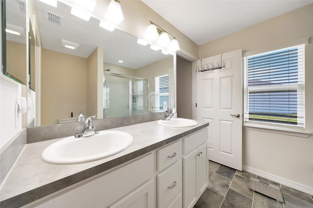 3418 SW 155th Pl, Ocala, FL 34473 - bathroom featuring double vanity, a shower stall, and baseboards