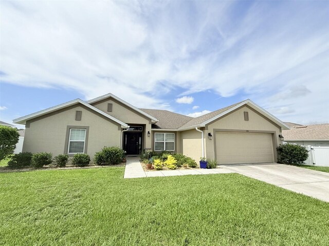 186 NW 44th St, Ocala, FL 34475 - ranch-style house featuring an attached garage, concrete driveway, stucco siding, and a front lawn