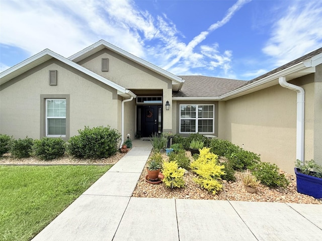 186 NW 44th St, Ocala, FL 34475 - entrance to property featuring stucco siding and a lawn