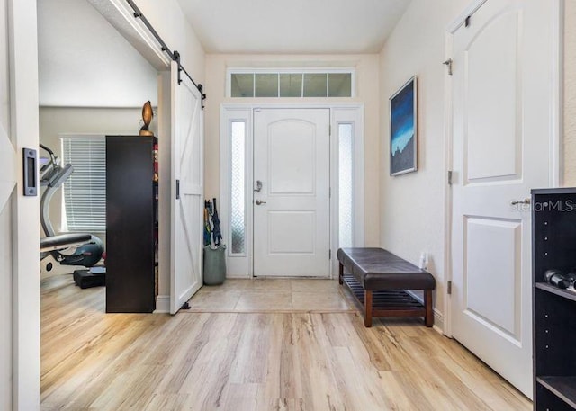 186 NW 44th St, Ocala, FL 34475 - foyer entrance featuring a barn door and light wood-style floors