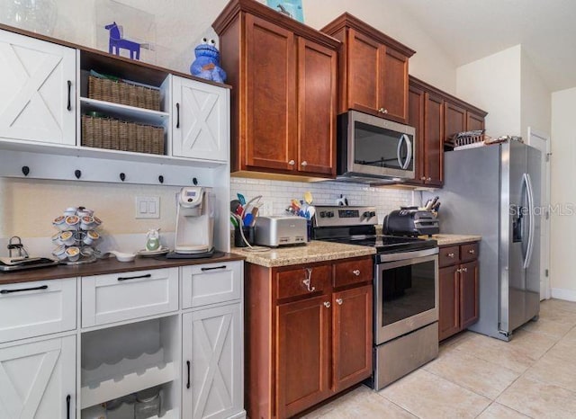 186 NW 44th St, Ocala, FL 34475 - kitchen with appliances with stainless steel finishes, decorative backsplash, light tile patterned floors, and light stone countertops