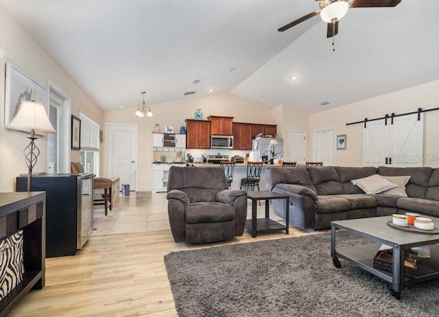 186 NW 44th St, Ocala, FL 34475 - living area featuring vaulted ceiling, a chandelier, ceiling fan, light wood-type flooring, and a barn door