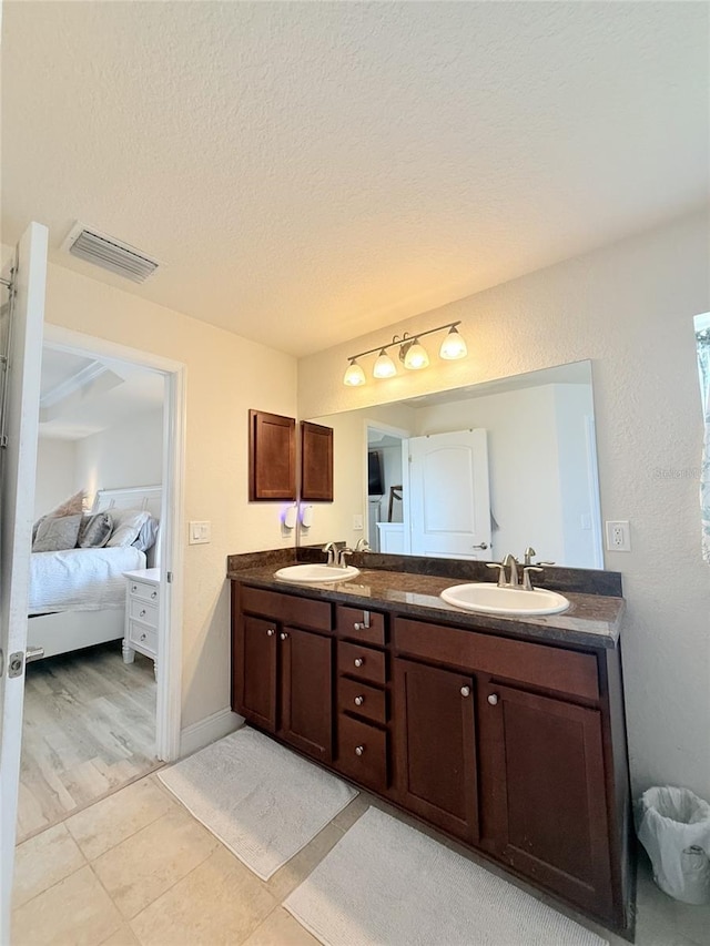 186 NW 44th St, Ocala, FL 34475 - ensuite bathroom with double vanity, a textured ceiling, and tile patterned floors