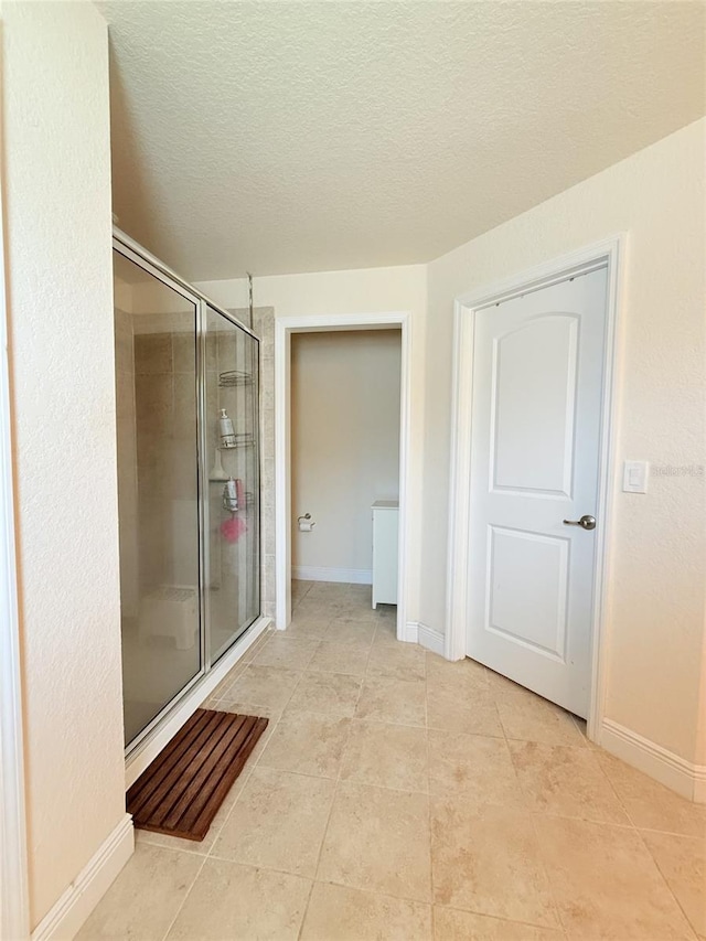 186 NW 44th St, Ocala, FL 34475 - full bath featuring a shower stall, a textured ceiling, and tile patterned floors
