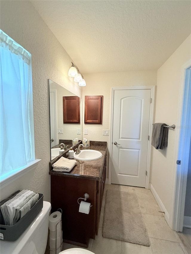 186 NW 44th St, Ocala, FL 34475 - bathroom with vanity, a textured ceiling, tile patterned floors, and a textured wall