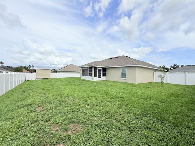 186 NW 44th St, Ocala, FL 34475 - rear view of property with a sunroom, a fenced backyard, and a storage unit