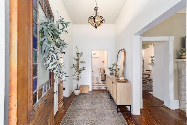 828 SE 3rd St, Ocala, FL 34471 - entryway featuring dark wood-style floors, baseboards, a chandelier, and a high ceiling