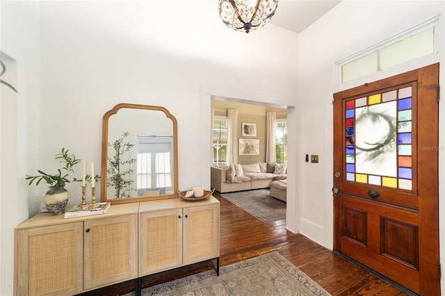 828 SE 3rd St, Ocala, FL 34471 - foyer entrance with dark wood-type flooring, a chandelier, and a high ceiling