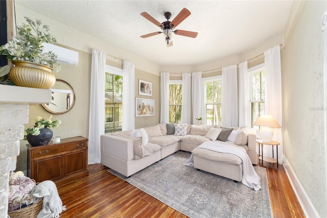 828 SE 3rd St, Ocala, FL 34471 - living area with wood finished floors, healthy amount of natural light, ceiling fan, a textured wall, and baseboards