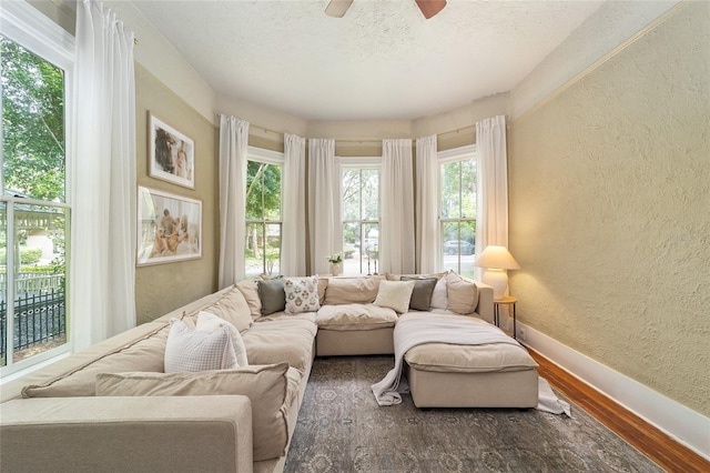 828 SE 3rd St, Ocala, FL 34471 - living area featuring a textured wall, baseboards, wood finished floors, a textured ceiling, and ceiling fan