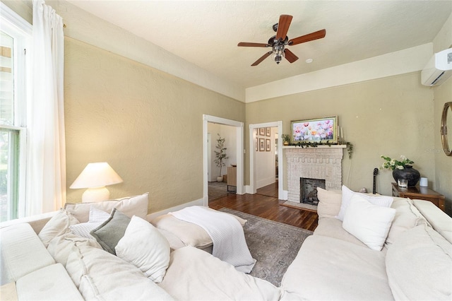 828 SE 3rd St, Ocala, FL 34471 - living area with ceiling fan, wood finished floors, a brick fireplace, a wall unit AC, and a textured wall