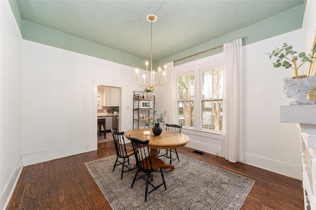 828 SE 3rd St, Ocala, FL 34471 - dining area featuring a chandelier, dark wood-style flooring, and baseboards