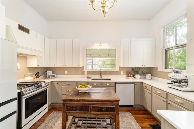 828 SE 3rd St, Ocala, FL 34471 - kitchen with stainless steel gas range oven, dishwasher, a sink, healthy amount of natural light, and ornamental molding