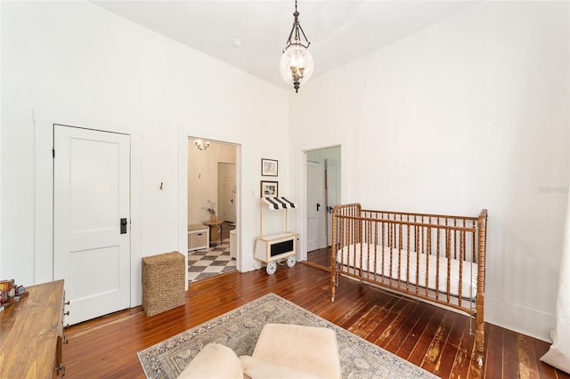 828 SE 3rd St, Ocala, FL 34471 - bedroom featuring hardwood / wood-style flooring, a towering ceiling, and baseboards