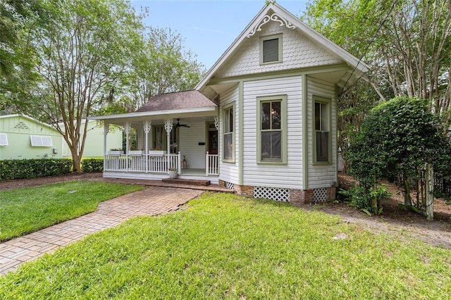 828 SE 3rd St, Ocala, FL 34471 - victorian house with covered porch, a front yard, and crawl space