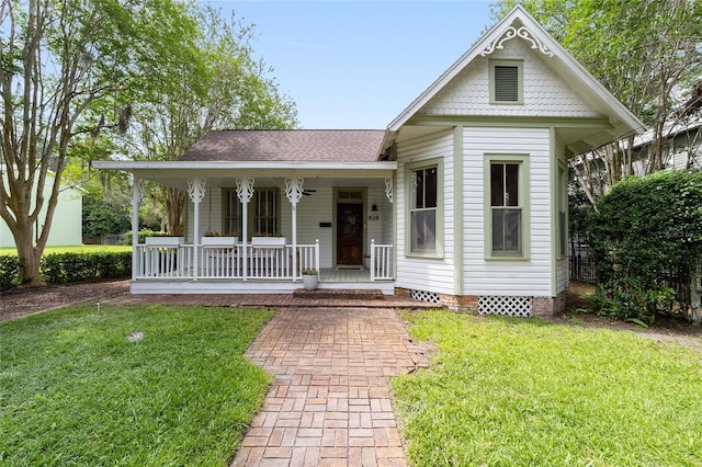 828 SE 3rd St, Ocala, FL 34471 - victorian-style house featuring covered porch, a front yard, a shingled roof, and crawl space