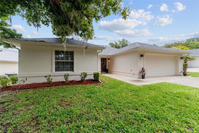 2644 SW 20th Cir, Ocala, FL 34471 - single story home featuring a garage, stucco siding, concrete driveway, and a front yard