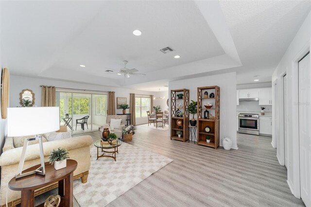2644 SW 20th Cir, Ocala, FL 34471 - living room featuring a raised ceiling, ceiling fan, light wood-style flooring, and recessed lighting